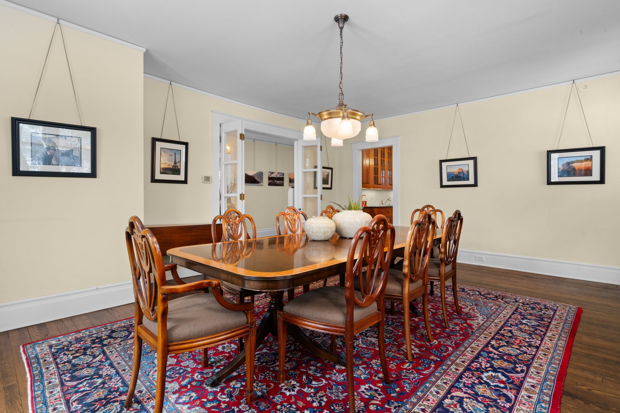 Formal Dining Room with wood floors and Rejuvenation Chandelier