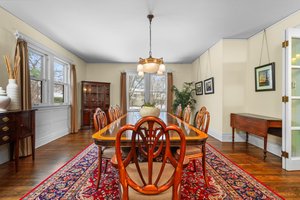 Formal Dining Room with wood floors and Rejuvenation Chandelier