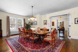 Formal Dining Room with wood floors and Rejuvenation Chandelier