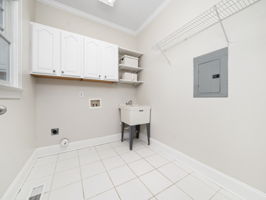 Main Floor Laundry with cabinetry & utlity sink