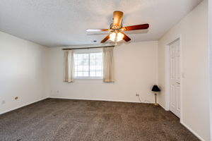 Primary bedroom with a walk-in closet