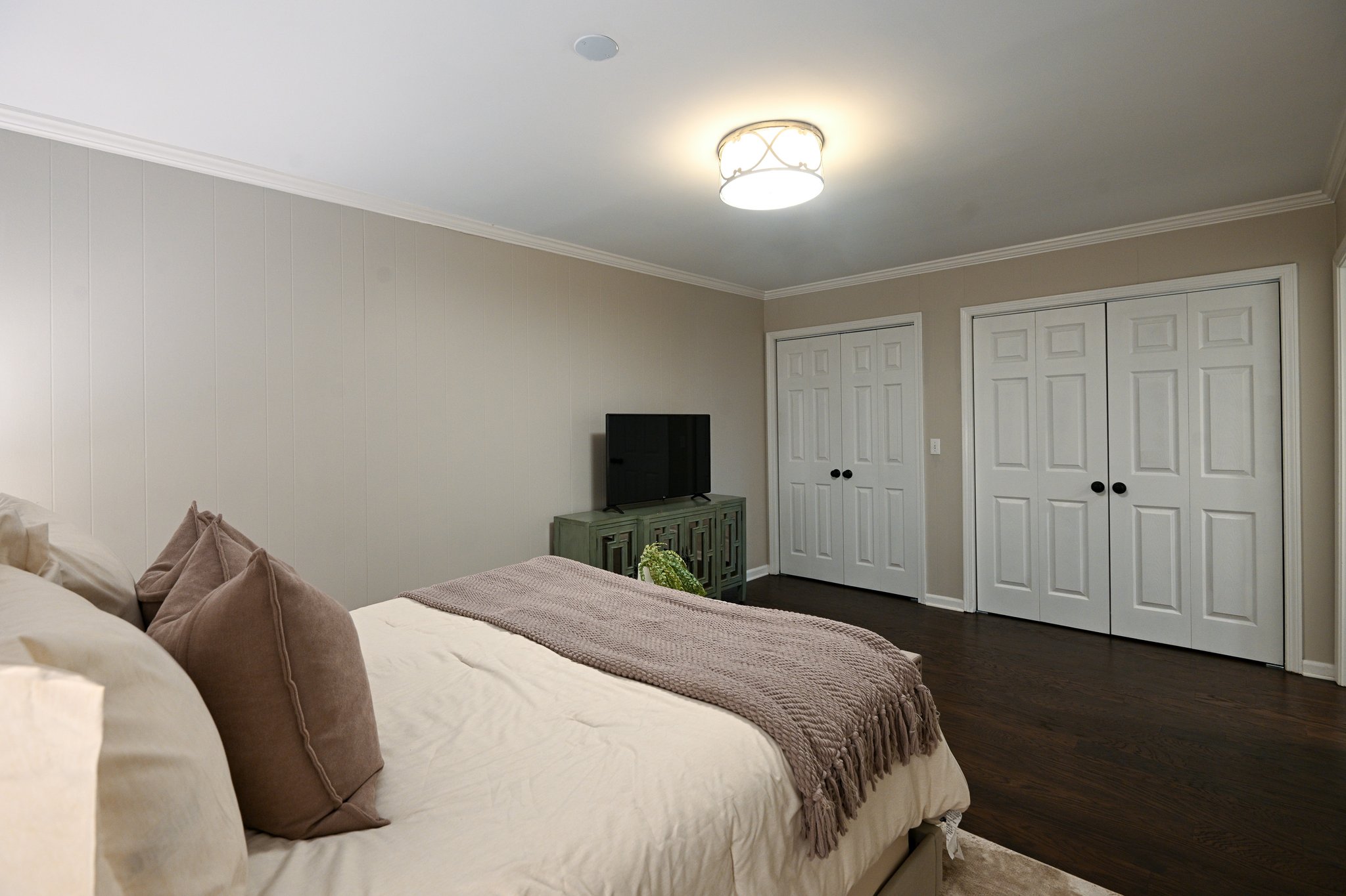 Entry level bedroom with a closet and laundry closet.