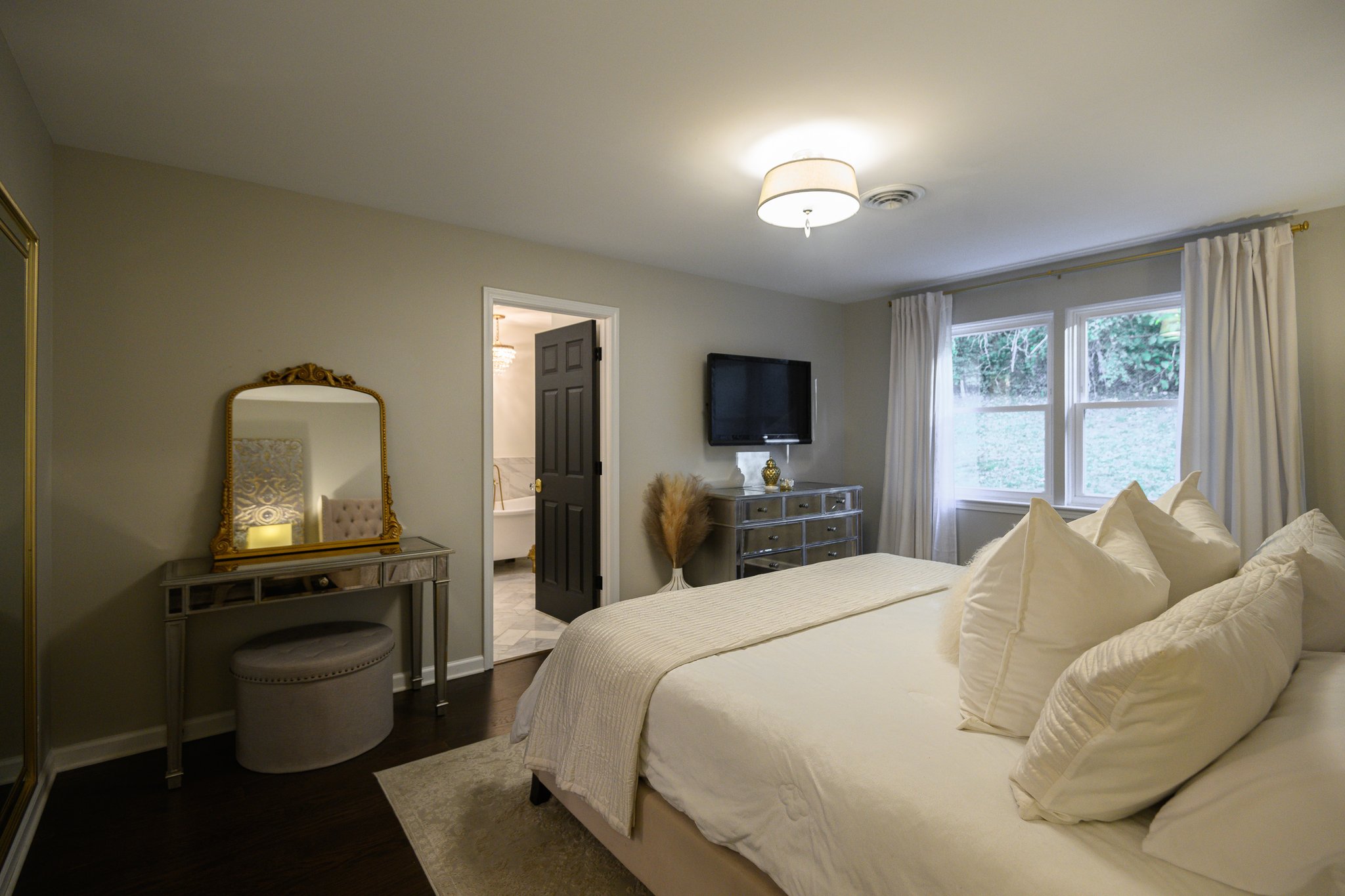 Spacious primary bedroom suite located on the upper level.