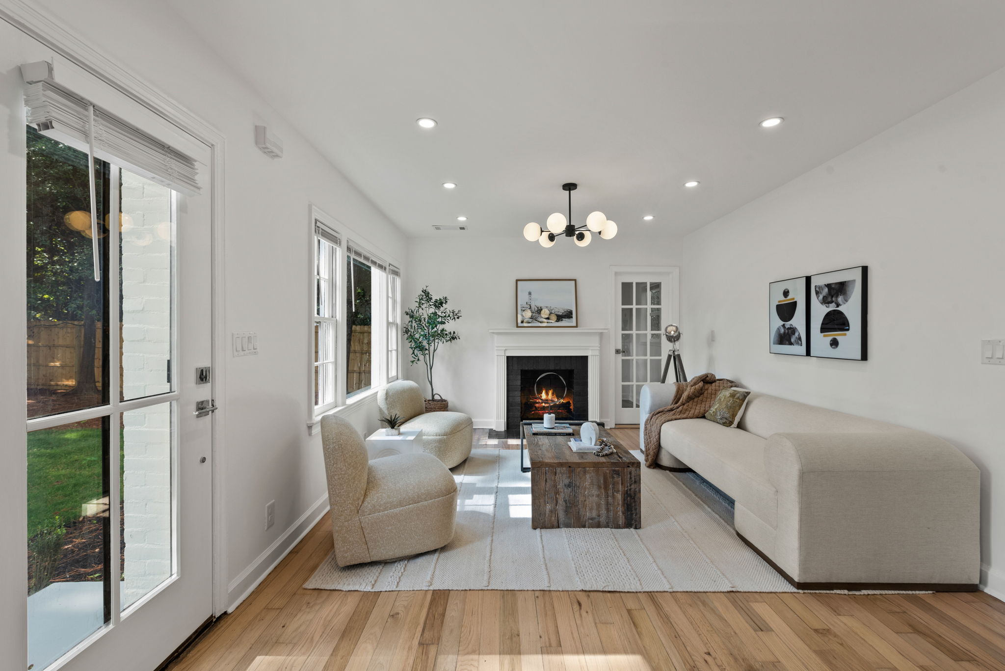 Living Room - Experience warmth and elegance in the living room, where a cozy fireplace and Nordic-style whitewash hardwood floors create a welcoming atmosphere.