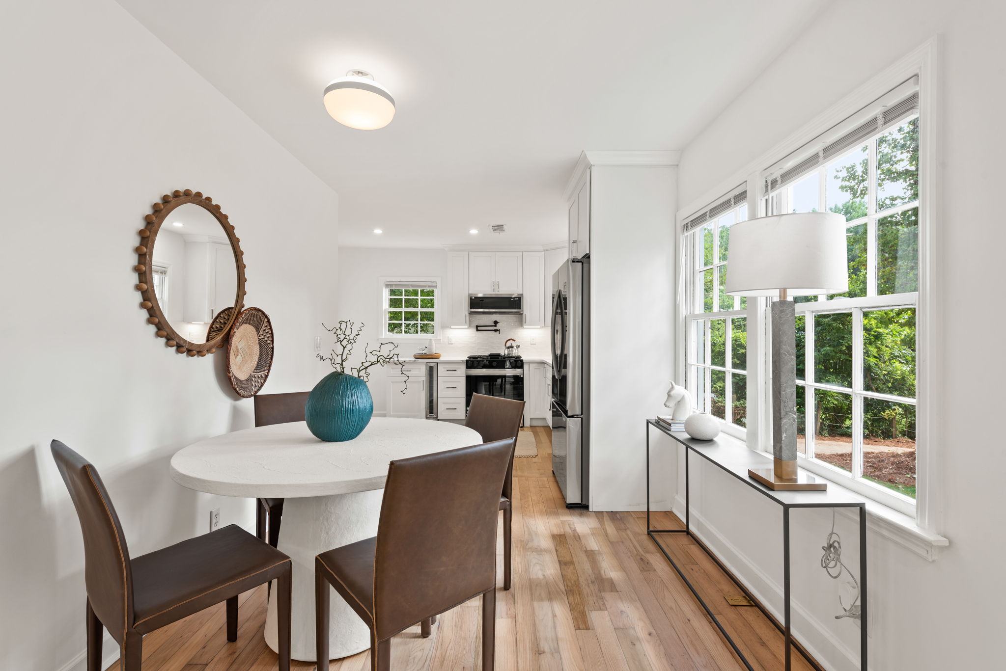 Dining Area - Host unforgettable meals in this open dining space, where expansive windows create the perfect setting for any occasion.