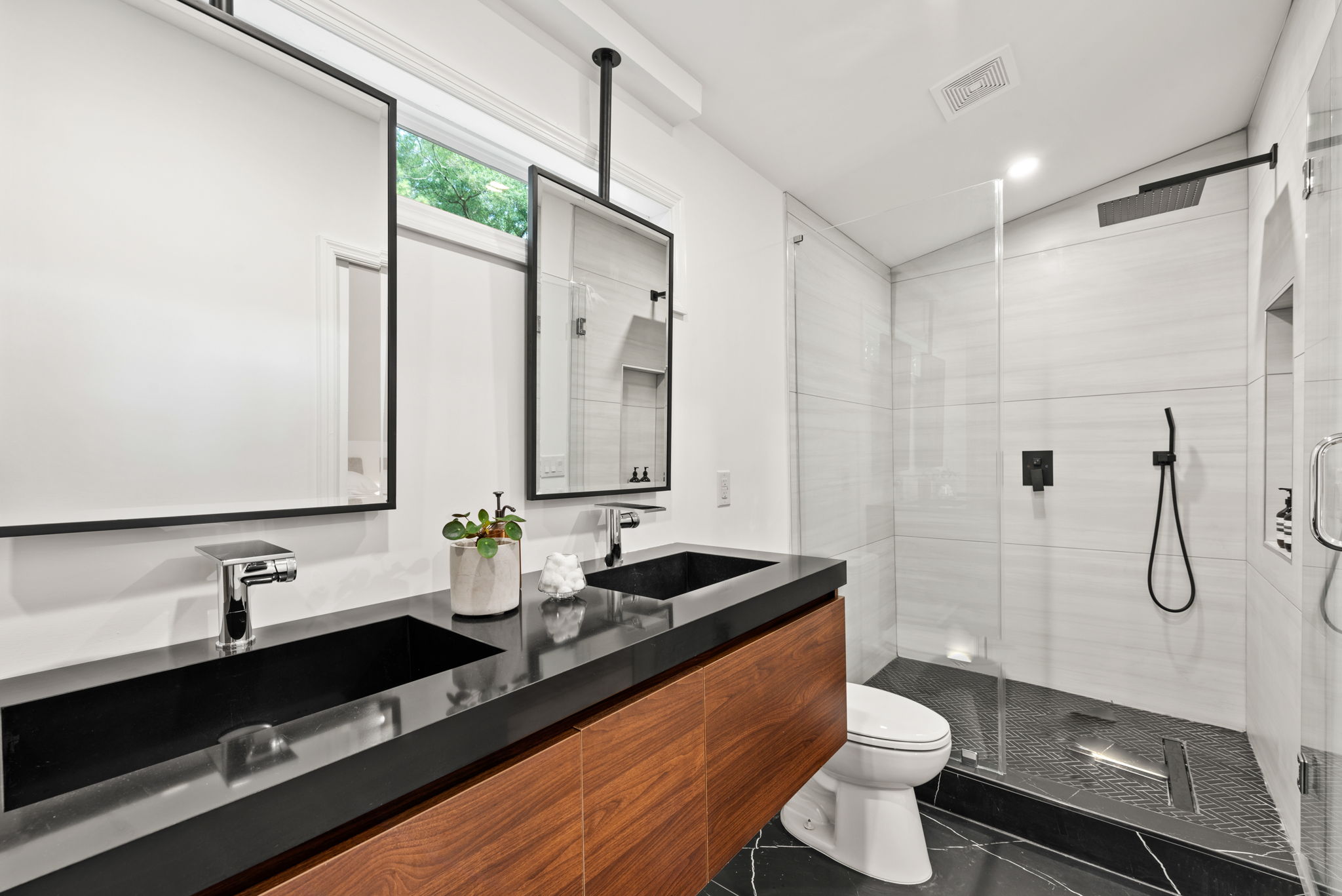 Primary Suite Bathroom - Experience ultimate relaxation in this spa-inspired bathroom, complete with a freestanding soaking tub, walk-in shower, and dual walnut floating vanity.