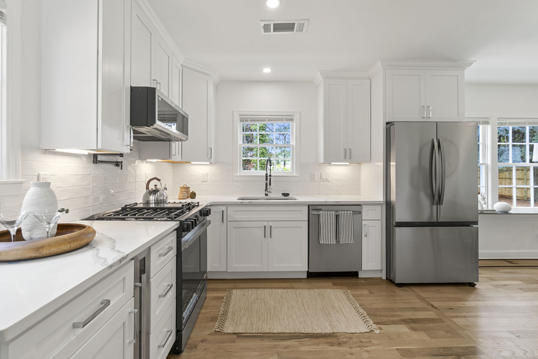 Kitchen - Culinary dreams come true in this gourmet kitchen featuring sleek stainless-steel appliances, quartz countertops, and high-end additions such as a built-in wine cooler, pot filler and glass rinser, to name a few.