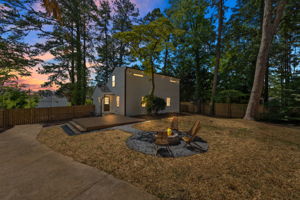 Backyard - Discover the backyard at night, where the fire pit sets the scene for cozy gatherings and roasting marshmallows under the stars. It's the perfect spot to unwind and enjoy the tranquil evening ambiance.