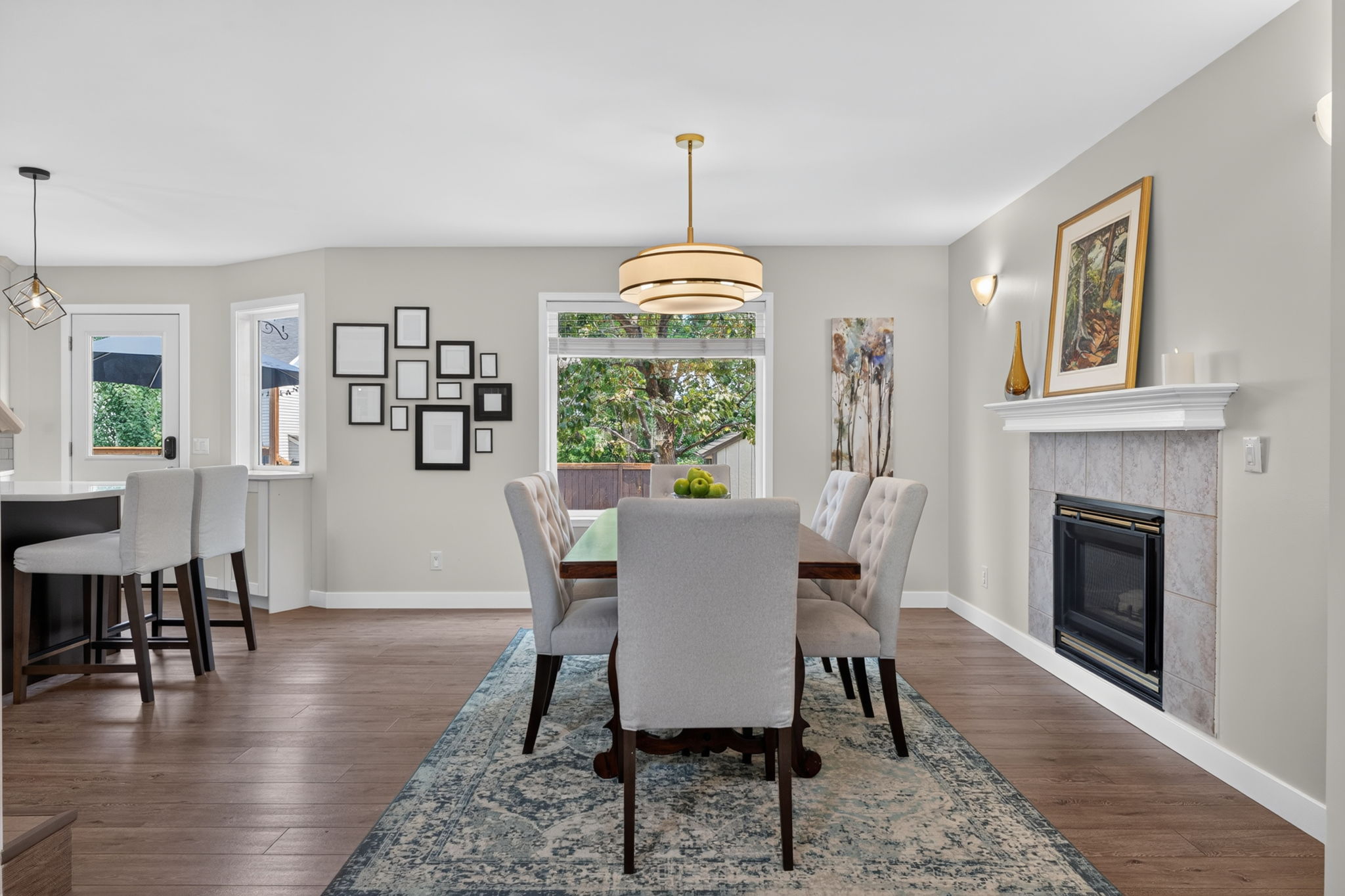 Fireside dining framed by a gallery wall
