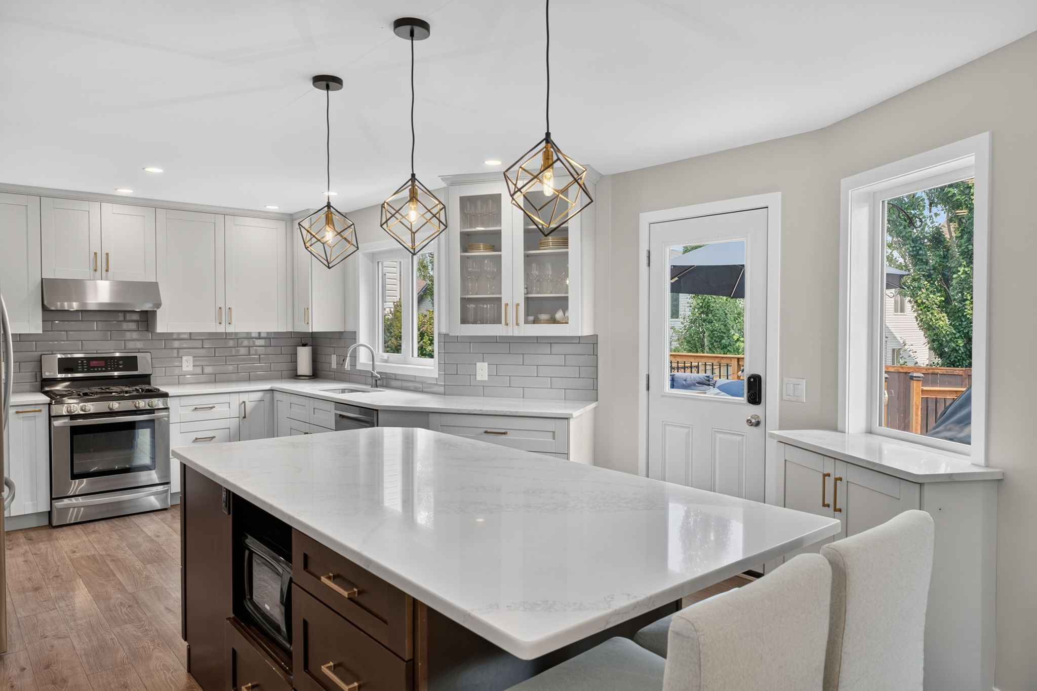 Crisp white kitchen with gas range & island