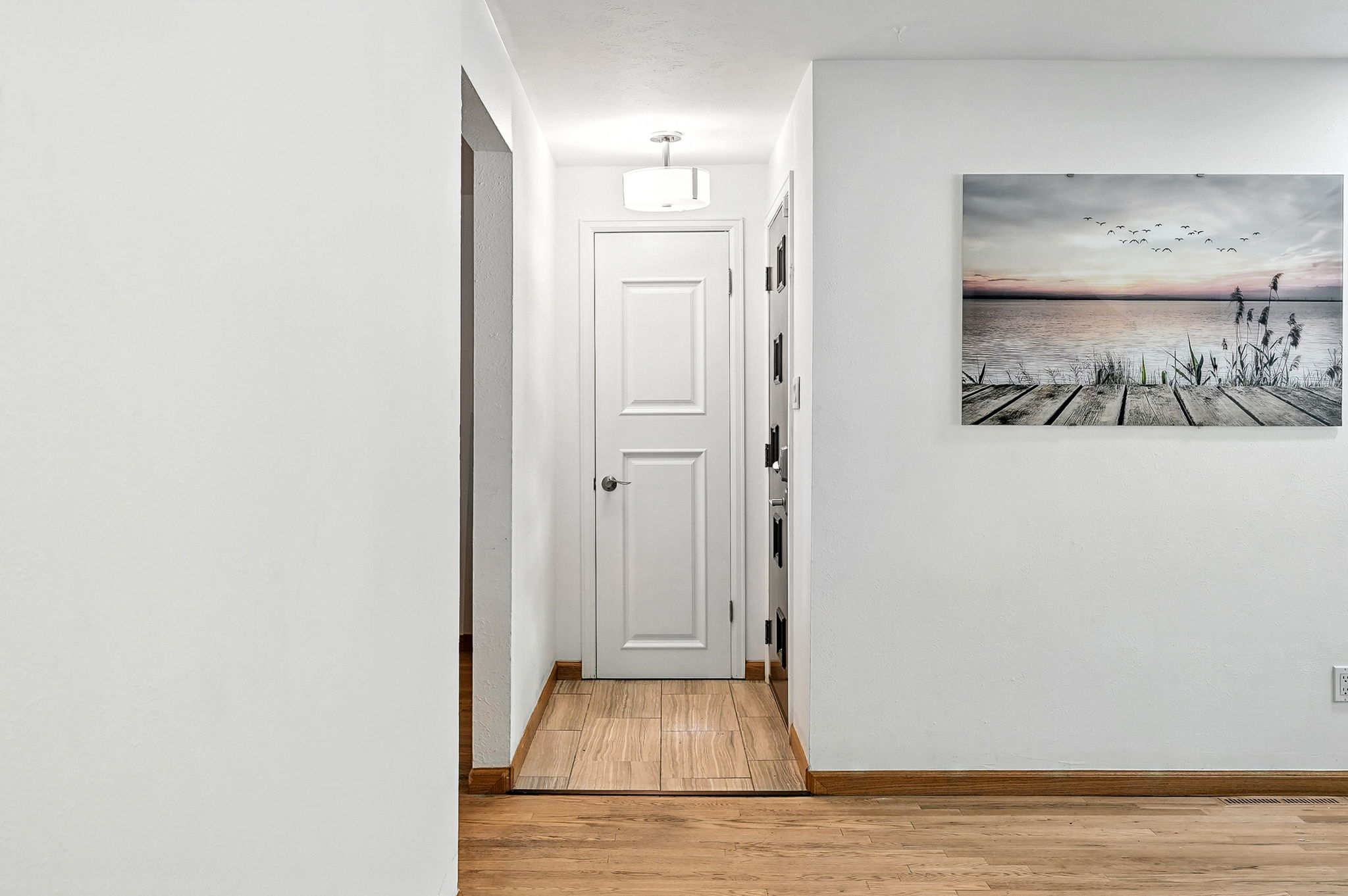 Tiled entry foyer with coat closet