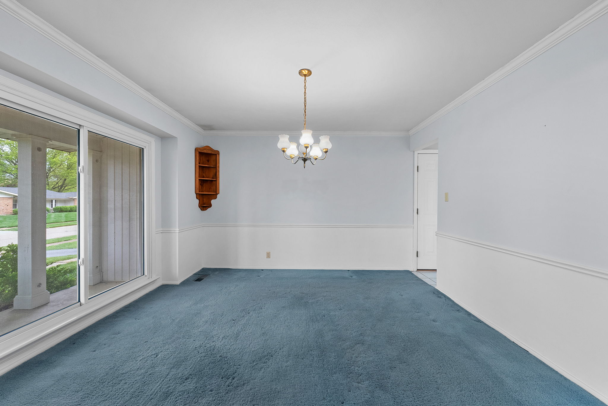 The formal dining room also boasts original hardwood floors beneath the carpet.