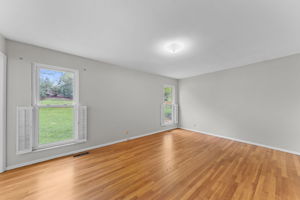 The primary bedroom, complete with original hardwood floors, is a spacious 18 x 18.