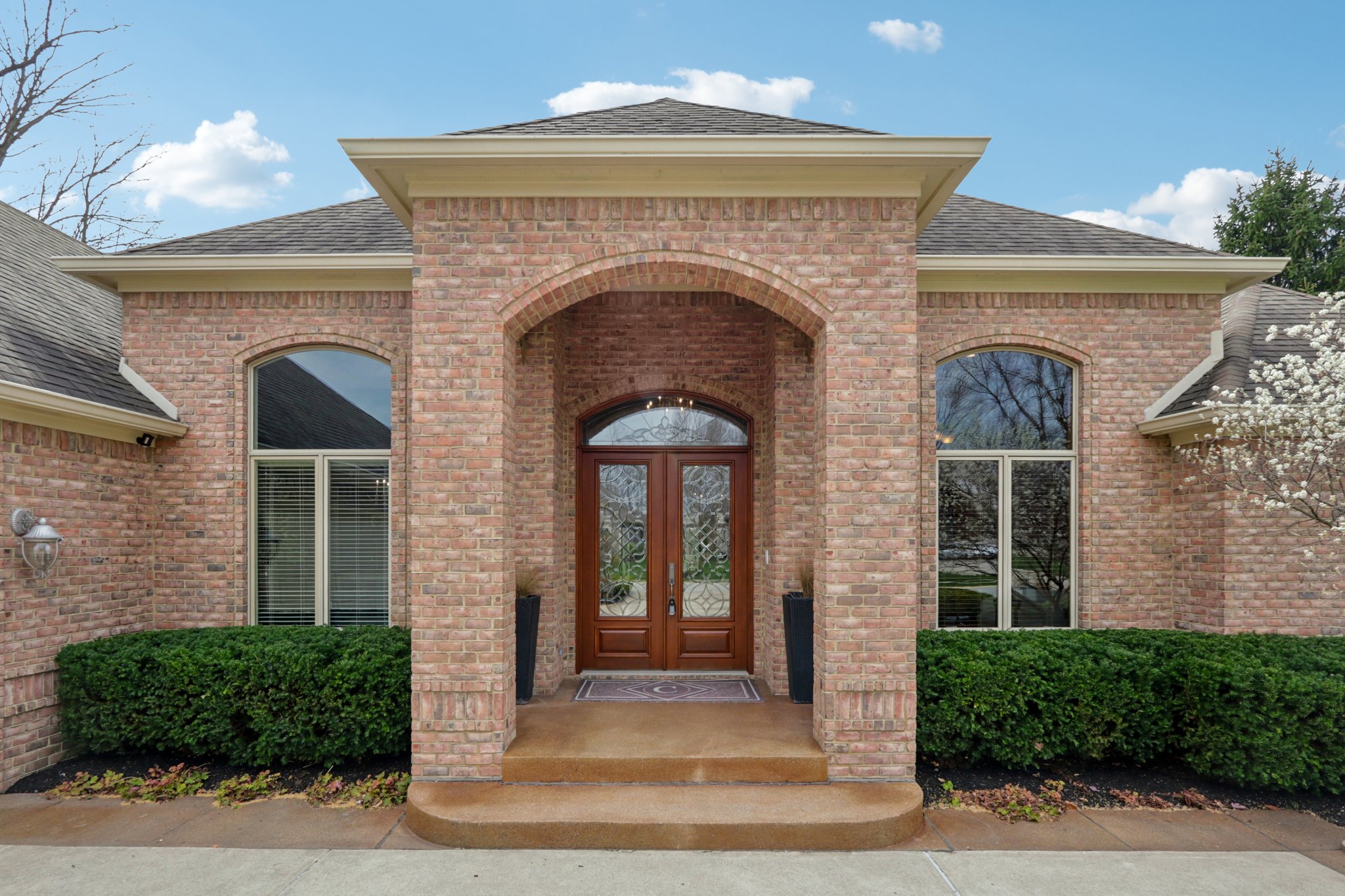 Luxurious covered entryway with leaded French doors