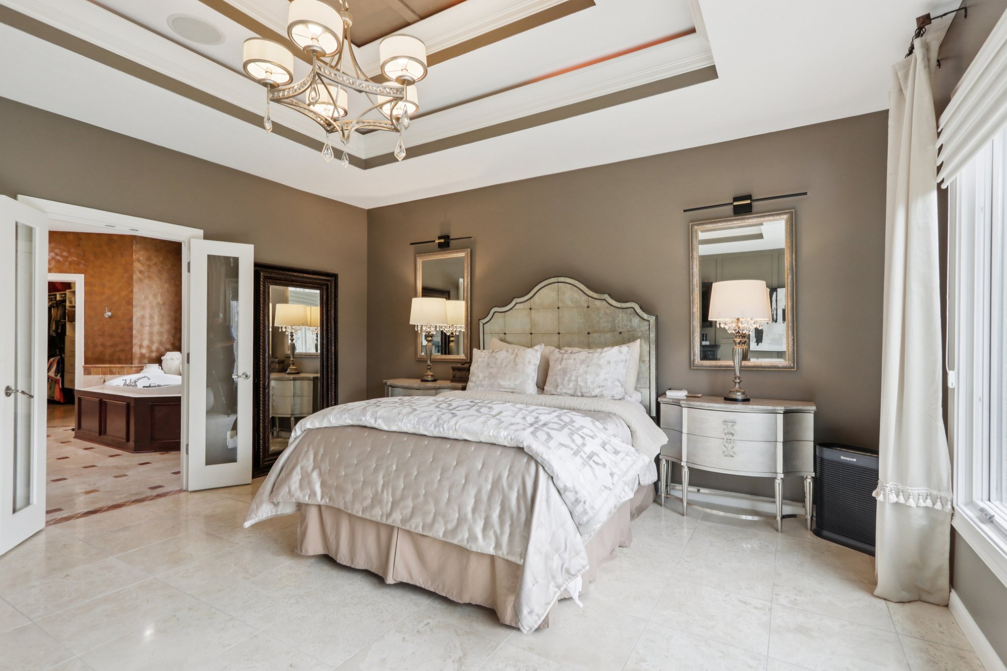 Elegant French doors open to the Primary Bathroom Suite