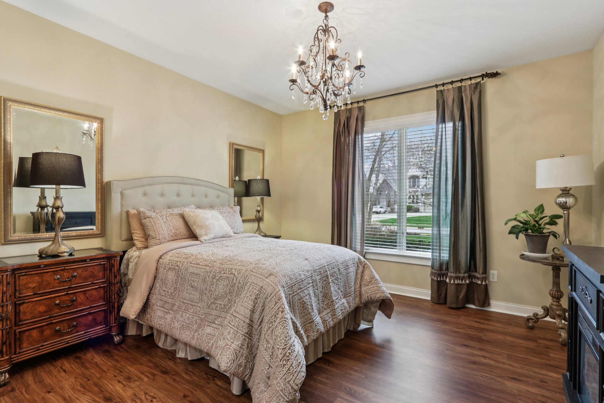 Split floorplan, Bedroom 2 on the main level offers plenty of space for guests or family with large closet, ensuite bathroom offering private vanity  and Jack-n-Jill water closet