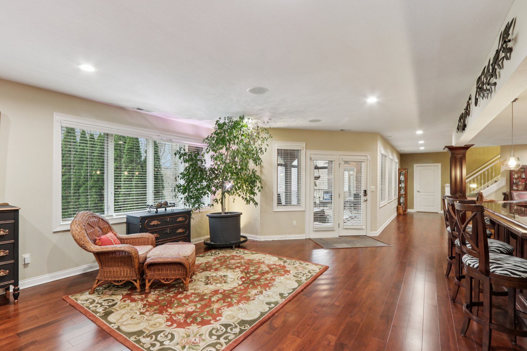 Tons of natural light floods the lower level from the many large windows all overlooking the private backyard entertaining area