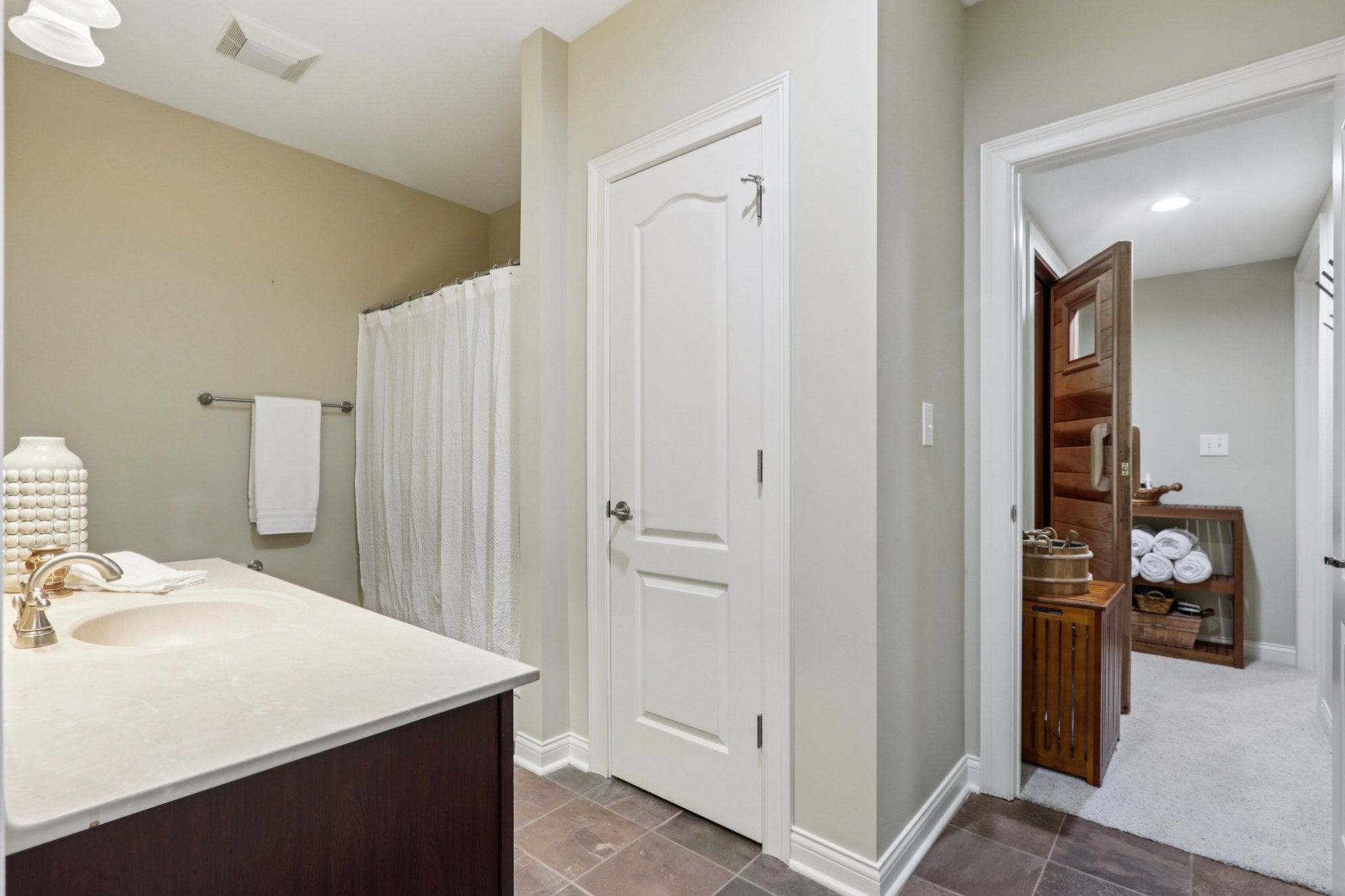 Full bathroom with tub/shower and linen closet is ensuite to Bedroom 4 and accessible from the Sauna and Exercise room