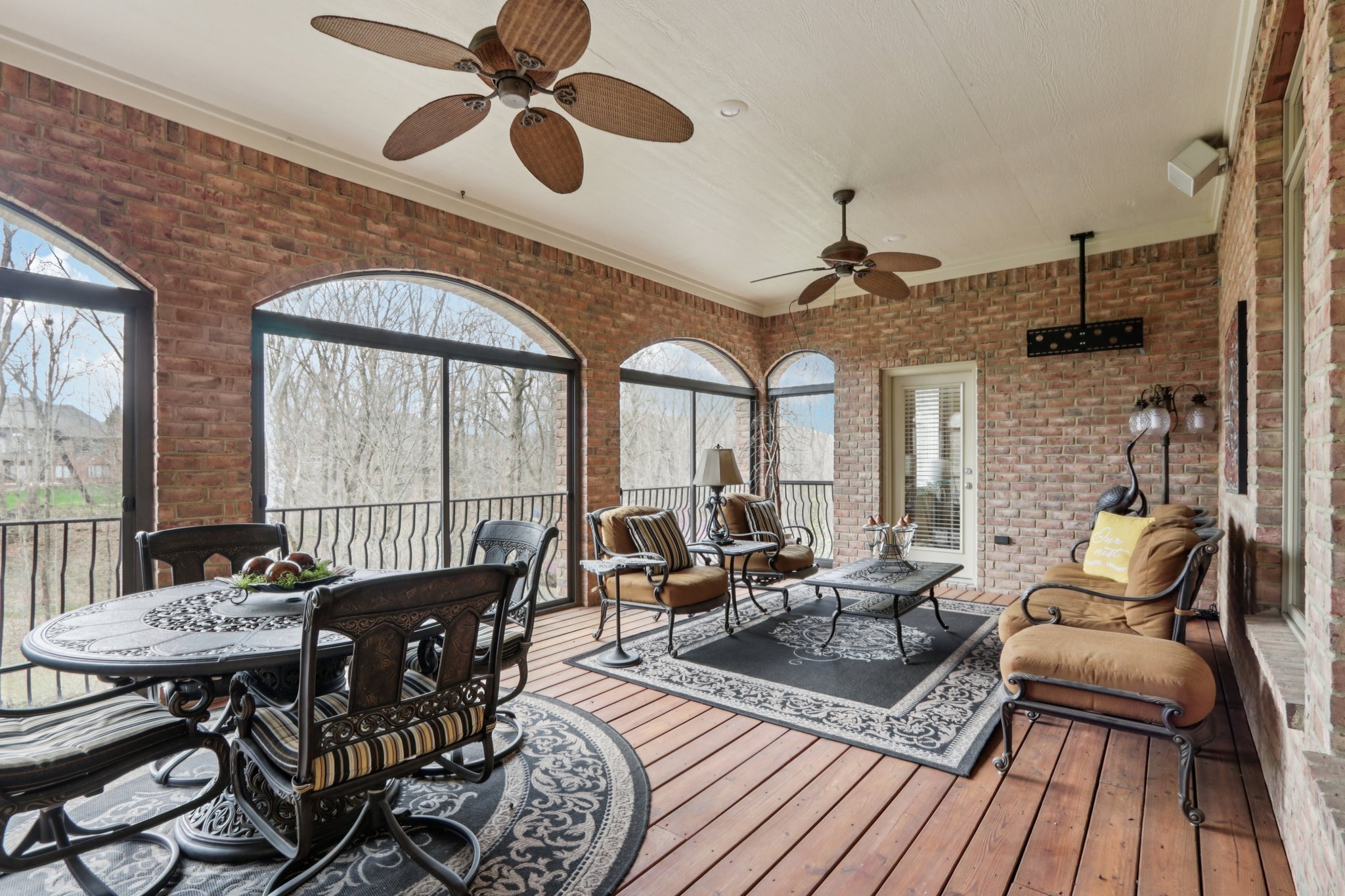 Main level Lanai with arched views of the stunning backyard is extends your living and entertaining area with plenty of room for dining al fresco or enjoying the natural surroundings