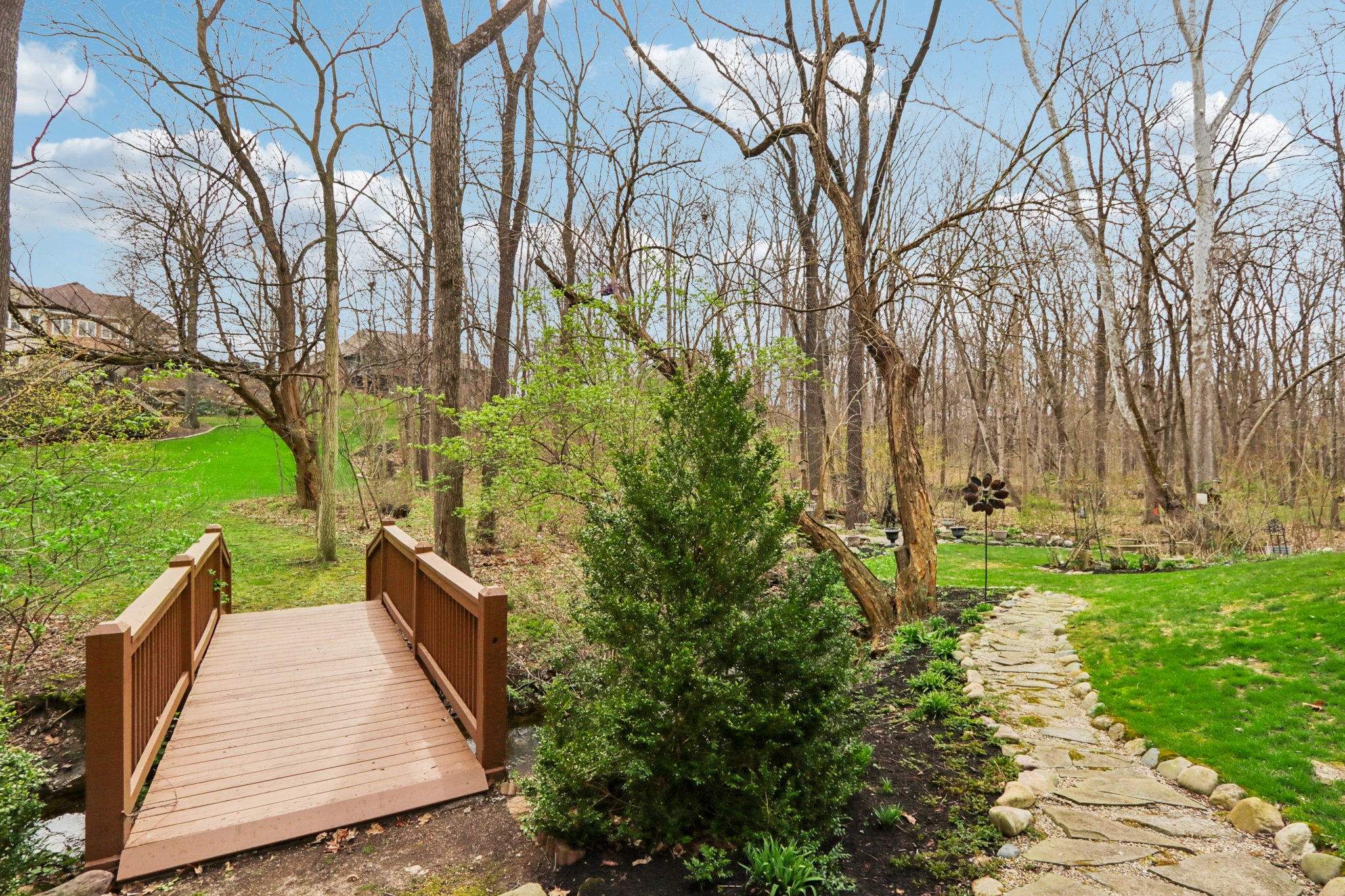 Bridge over the creek to lush green space