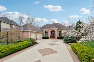 Welcome to 14575 Geist Ridge Drive a custom all brick ranch home with walk-out lower level with picturesque outdoor space with bubbling creek, paver patio with fireplace, 2 Lanais and more