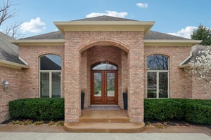 Luxurious covered entryway with leaded French doors