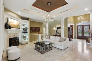 Great room offers ornamental molding, tall ceilings, travertine flooring and surround sound system perfect for entertainment and gathering