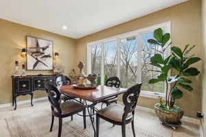 Sunny and bright breakfast area with decorative lighting overlooks overlooks the private outdoor oasis and offers access to the main level Lanai