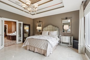Elegant French doors open to the Primary Bathroom Suite