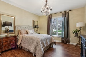 Split floorplan, Bedroom 2 on the main level offers plenty of space for guests or family with large closet, ensuite bathroom offering private vanity  and Jack-n-Jill water closet