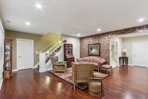 Lower level offers tall ceiling, recessed lighting, hardwood flooring in the Family Room area