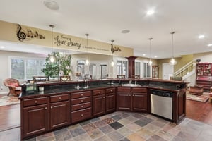 Fully equipped wet bar with dishwasher and stained cabinetry