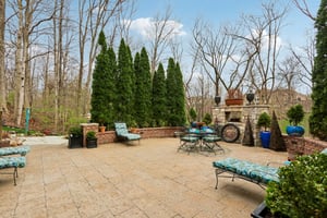 Enjoy the outdoor fireplace from the large paver patio where privacy abounds
