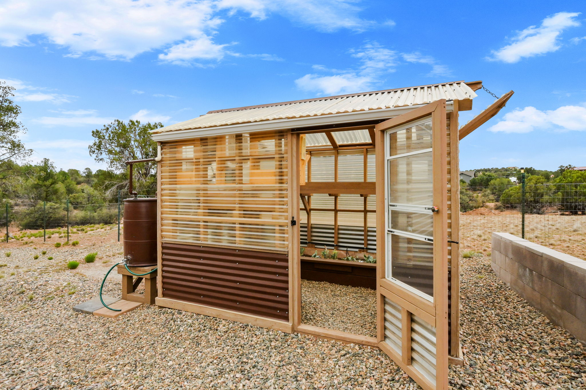 Greenhouse with Rain Collection Barrels