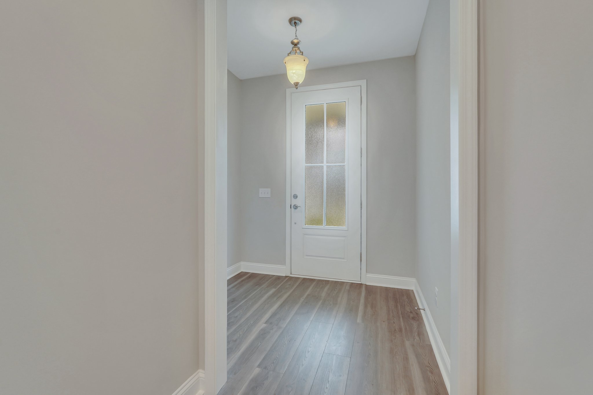 Entryway with upgraded front door with frosted glass