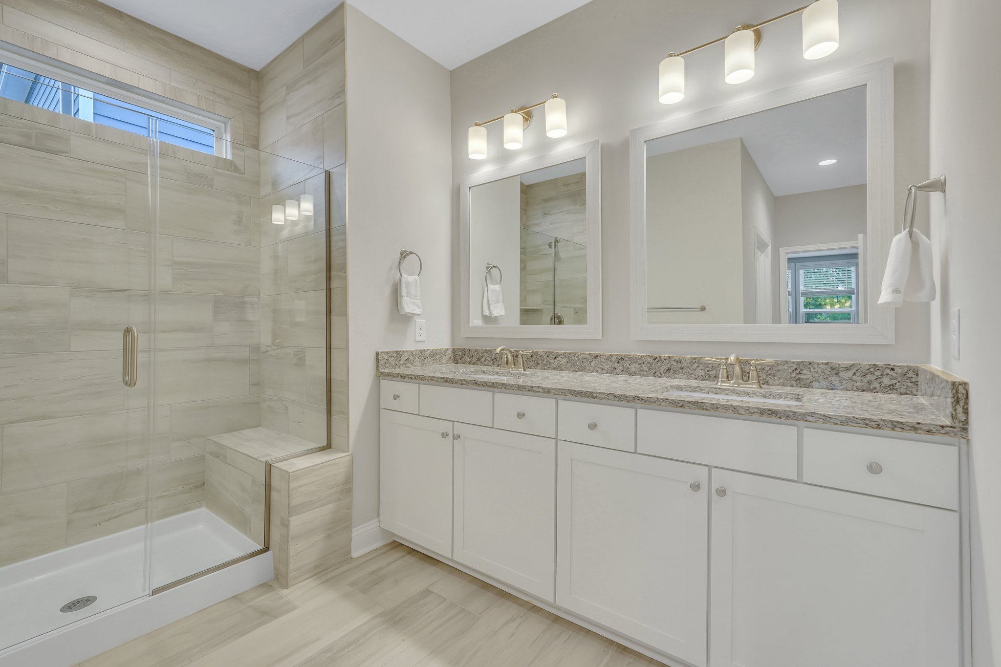 Primary Bathroom with upgraded tile, walk-in shower with bench