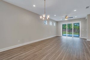 Open floor plan with sliders going out to screened porch