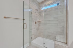 Upgraded Glass, Tile & Bench in Primary Shower