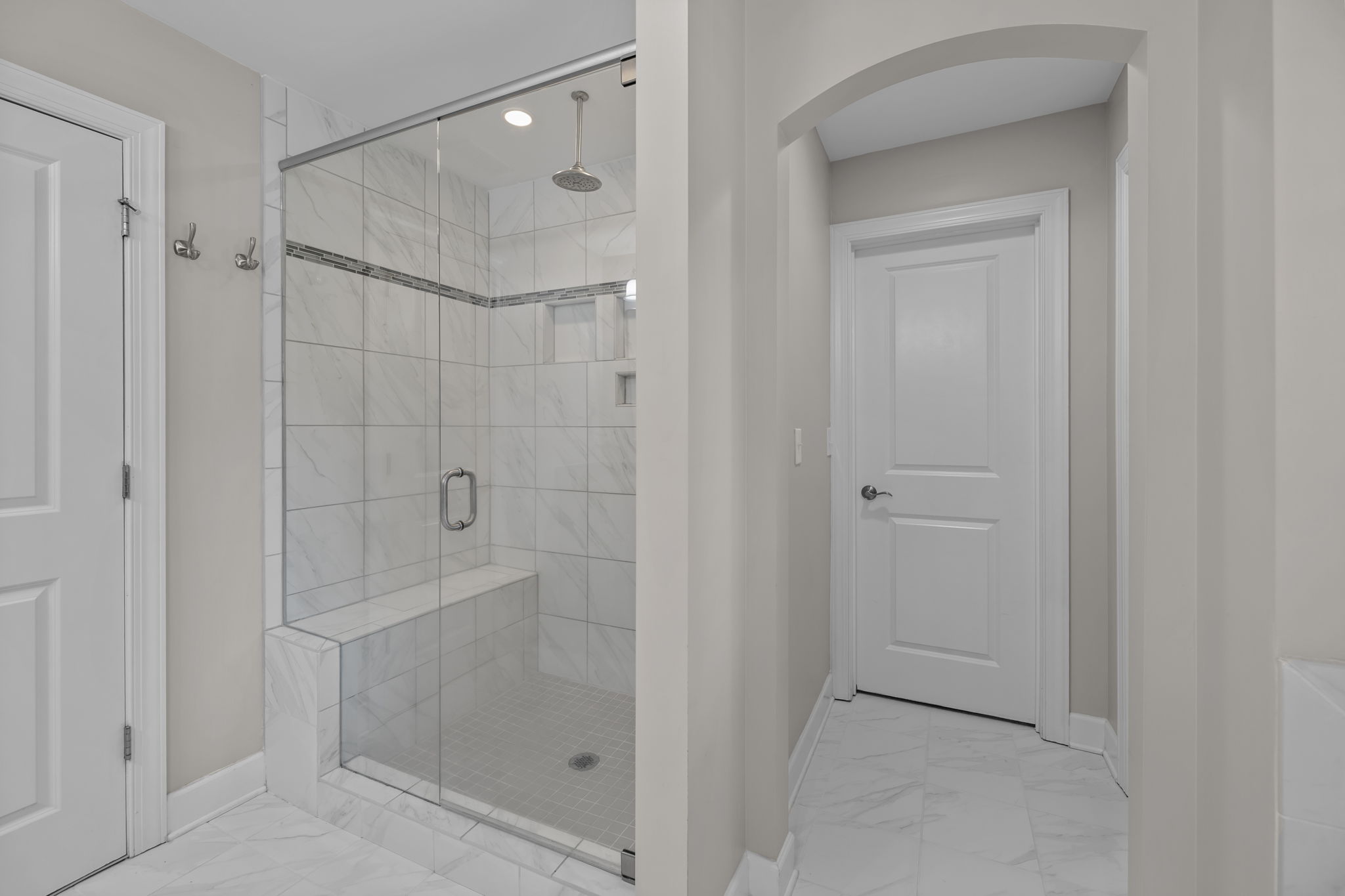 Rainfall shower and custom closet in primary bedroom