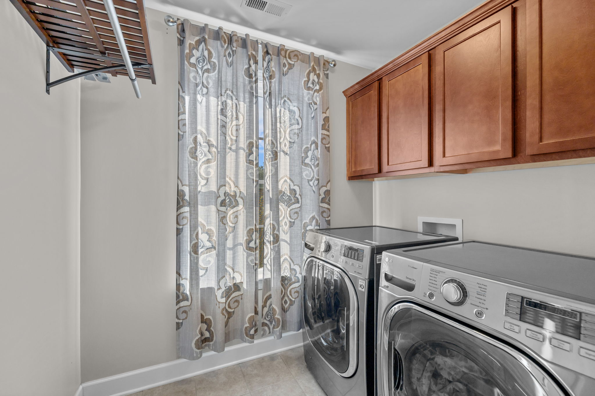 Laundry room with cabinetry on second level