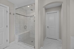 Rainfall shower and custom closet in primary bedroom