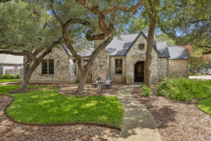 Rock home with mature trees