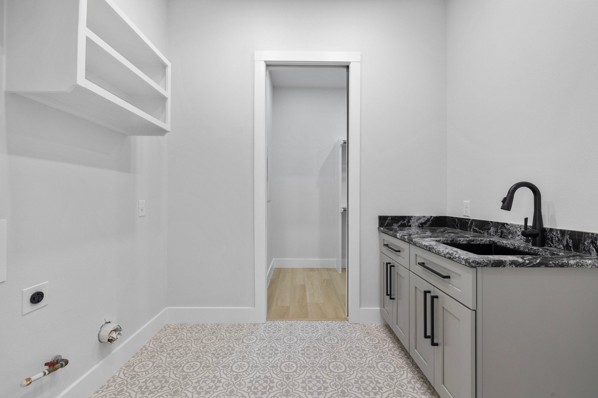 One of two laundry rooms. This is on the lower level near the primary bedroom. The other laundry room is on the upper level near the game room.