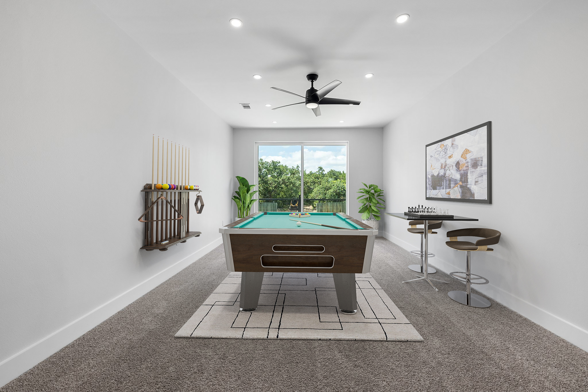 Game room on the upper level with a patio overlooking the back yard. Virtually staged.