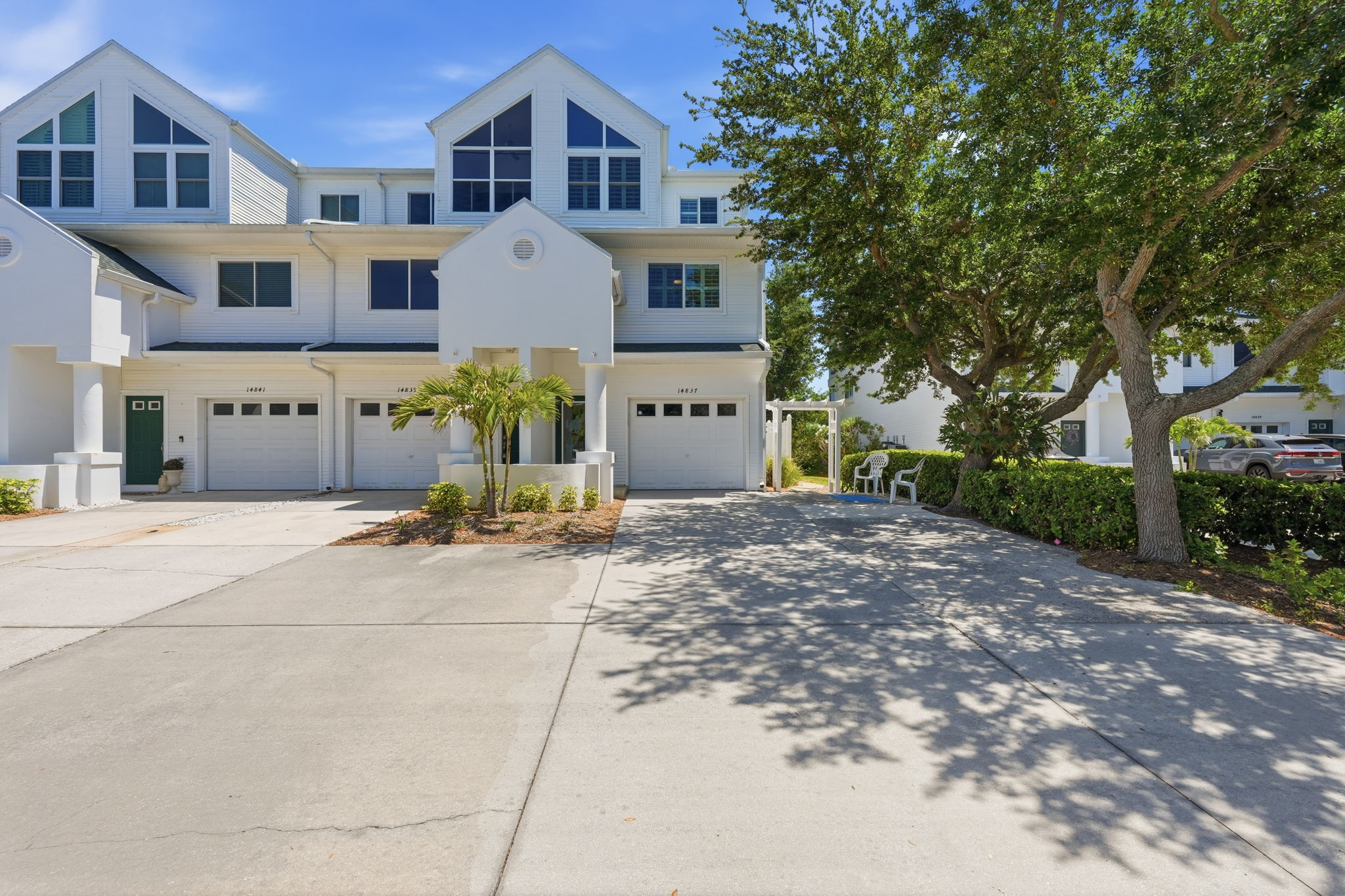 Double wide driveway with side concrete steps to waterfront