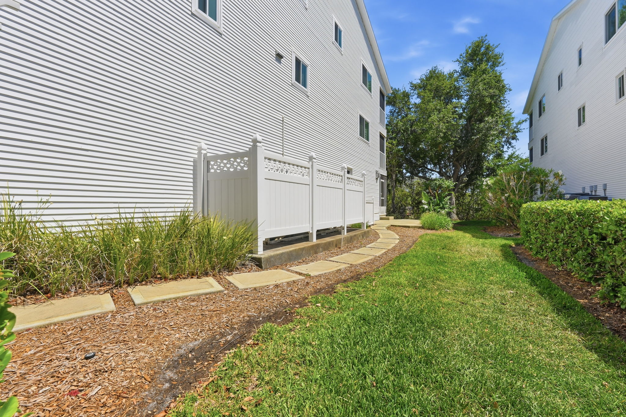 Concrete steps to rear of townhome from driveway.