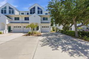Double wide driveway with side concrete steps to waterfront