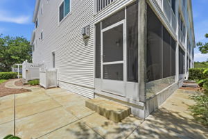 Open concrete patio with concrete walkway to driveway