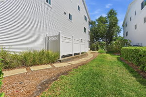 Concrete steps to rear of townhome from driveway.