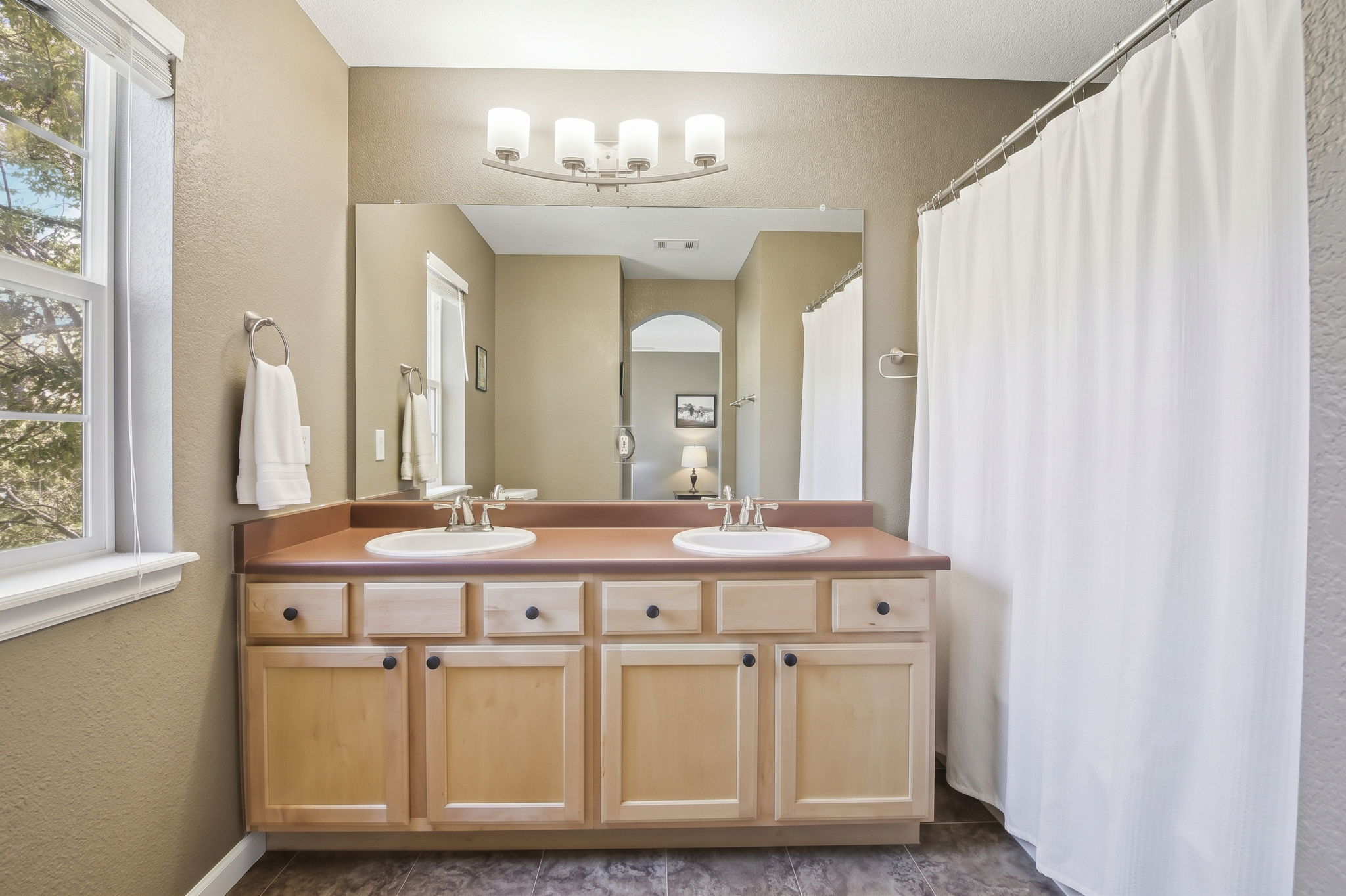 Spacious primary bathroom with double vanity sinks